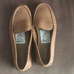 Calvin Klein Tan Loafers with gold accents.